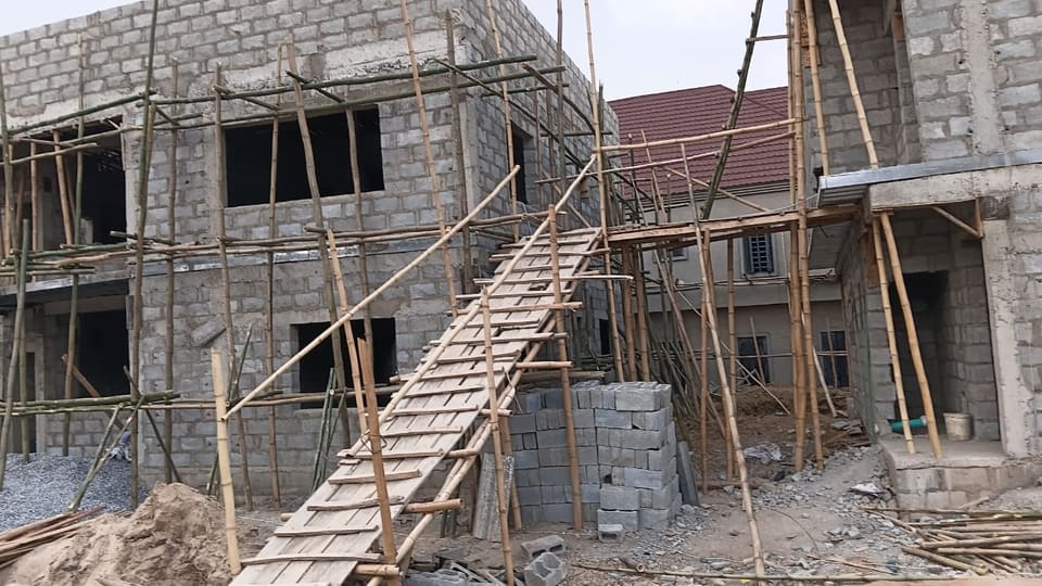 Timber access stair and scaffolded blockwork on site, 2026