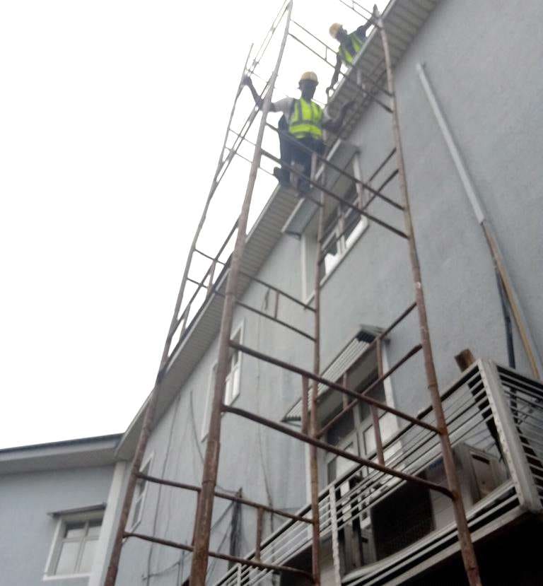 Workers on scaffolding beside the branch facade — Onipanu, Lagos