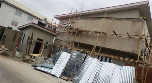 Before: side elevation with scaffolding and roofing sheets — Oluwaleimu Street, Ikeja, Lagos