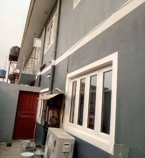 After: side elevation with new window surrounds — Oluwaleimu Street, Ikeja, Lagos