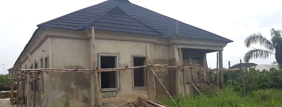Front view of the roofed structure with scaffolding — Unity Estate, Badore, Lagos